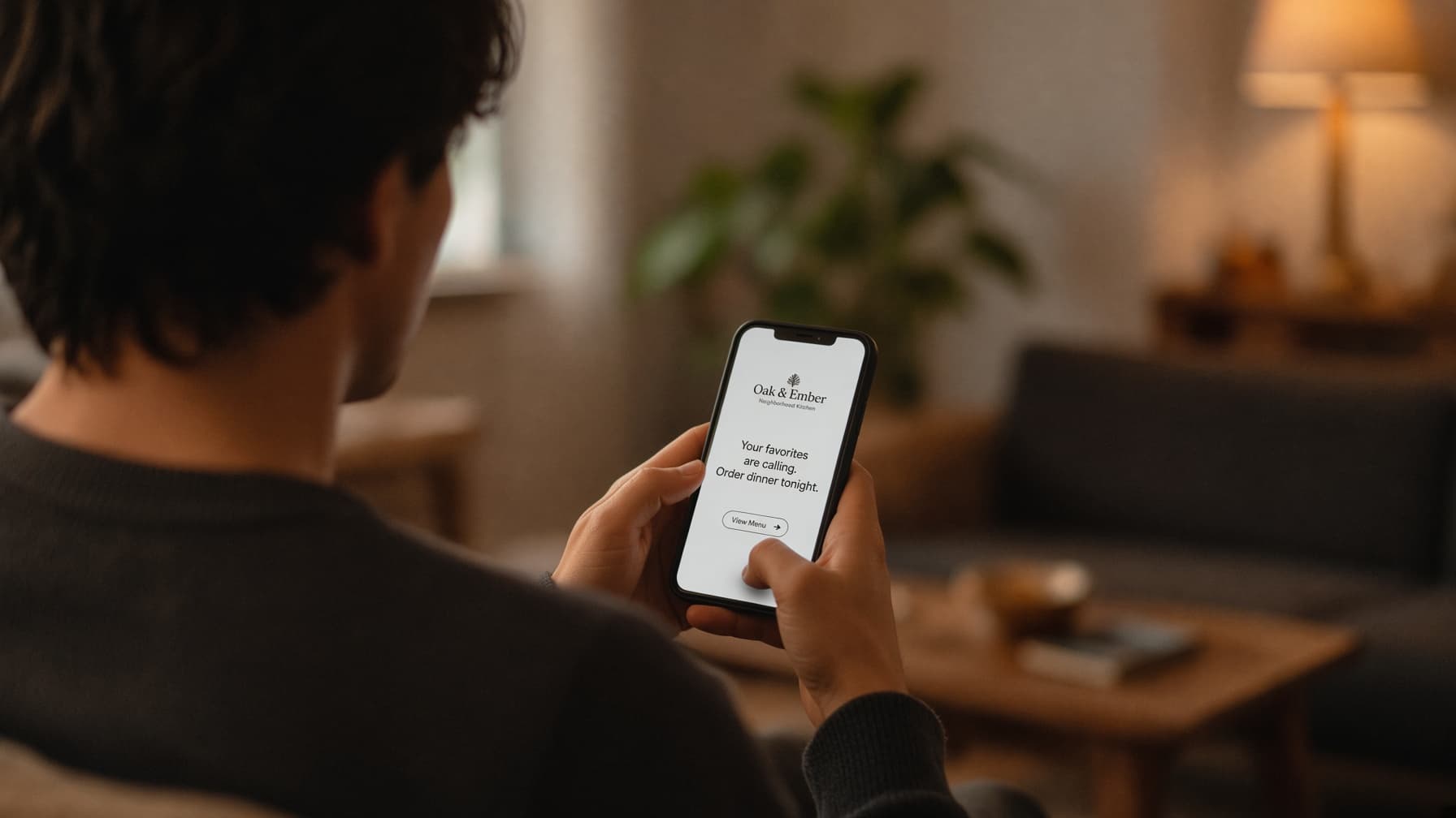 A customer reading a restaurant's message on their phone at home